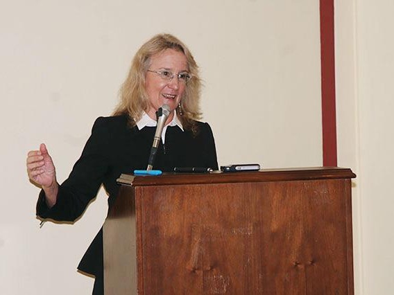 Carol A. Barnes, Ph.D. behind the podium