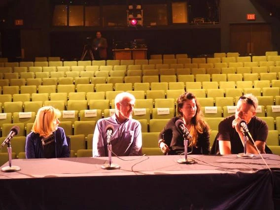 four people behind the desk and mic