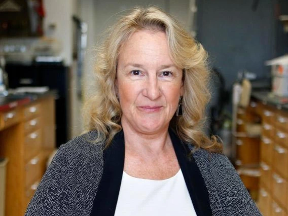 Carol A. Barnes, Ph.D. sitting on a chair